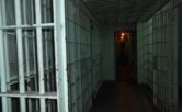 Photograph of a prison hall styled dramatically to emphasise the horror