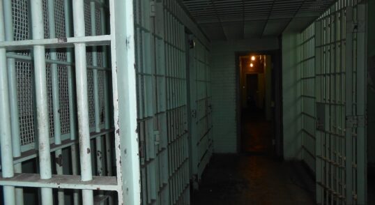 Photograph of a prison hall styled dramatically to emphasise the horror