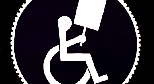 Graphic of a person in a wheelchair holding a blank protest sign